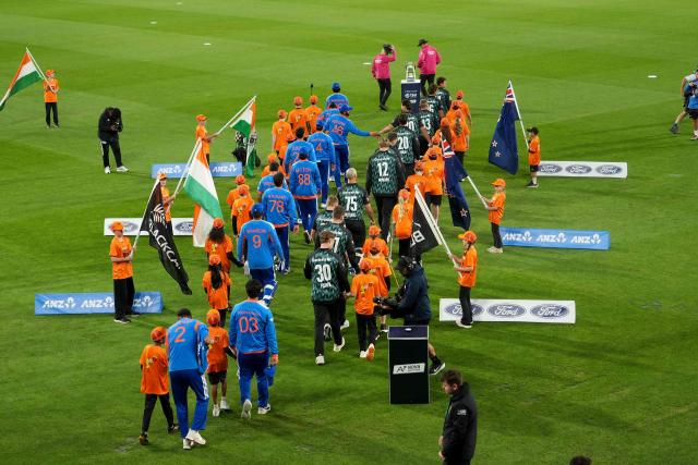 New Zealand (R) and India's teams walk onto the field for national anthems during the 3rd T20 cricket match between New Zealand and India at the HNRY Stadium in Wellington on October 27, 2026. (Photo by Marty MELVILLE / AFP)