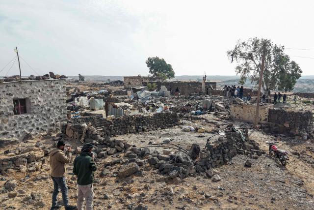 EDITORS NOTE: Graphic content / This picture shows an aerial view of people inspecting the damage at a site targeted by airstrikes, carried out the night before by Jordan on the village of Al-Taf in the Al-Lajat region, located in the northeastern countryside of Daraa, on October 27, 2026. Jordan said on October 27 it had killed more than 20 Islamic State group jihadists in strikes on Syria conducted the day before, in retaliation for a deadly attack on a church. (Photo by Bakr ALkasem / AFP)