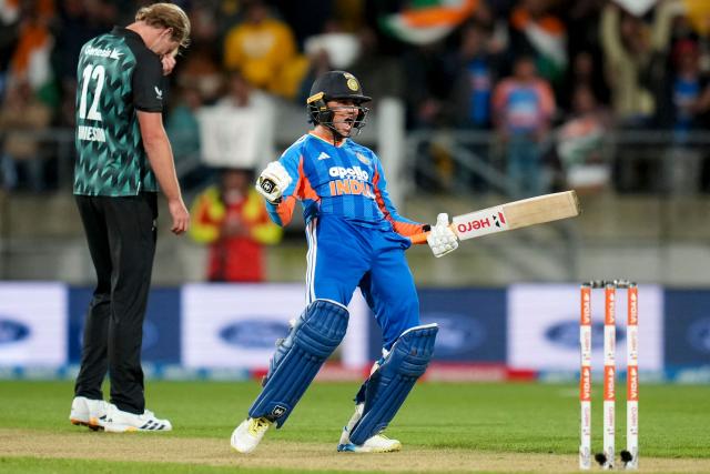 New Zealand Kyle Jamison (L) reacts as India's Abhishek Sharma celebrates after reaching his century (100 runs) during the 3rd T20i cricket match between New Zealand and India at the Hnry Stadium in Wellington on October 27, 2026. (Photo by Marty MELVILLE / AFP)