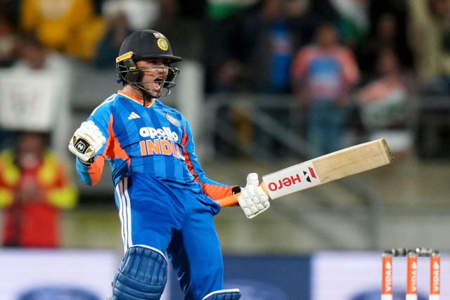 India's Abhishek Sharma celebrates 100 runs during the 3rd T20 cricket match between New Zealand and India at the HNRY Stadium in Wellington on October 27, 2026. (Photo by Marty MELVILLE / AFP)