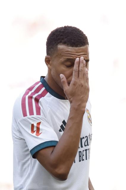 (FILES) Real Madrid's French forward #10 Kylian Mbappe gestures during the Spanish league football match between Club Atletico de Madrid and Real Madrid CF at the Metropolitano stadium in Madrid on September 20, 2026. Kylian Mbappe was dropped on October 27 by two major brands in China after a video circulated online in which the French football star apparently joked about former leader Mao Zedong. (Photo by Oscar DEL POZO / AFP)
