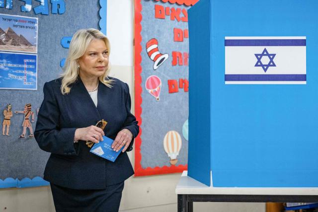 Sara Netanyahu, wife of Israel's Prime Minister Benjamin Netanyahu, reacts after filling out her ballot before voting at a polling station in Jerusalem on October 27, 2026, on the day of Israel's legislative election. Netanyahu called on Israelis to vote "the right way" on October 27 as he cast his ballot in Jerusalem, facing a close-fought race in a pivotal general election. Israelis are flocking to the polls for the first time since Hamas's October 7, 2023 attack, with a deeply divided electorate delivering their verdict on the veteran leader. (Photo by Yonatan Sindel / POOL / AFP)