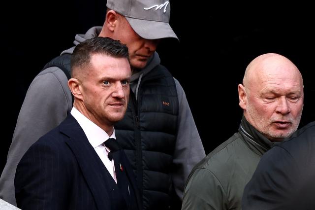 British far-right activist Tommy Robinson (front L), real name Stephen Yaxley-Lennon, arrives at the Southwark Crown Court in London on October 27, 2026. Robinson, who is being tried under his real name, has denied charges of harassing two journalists through his X account between August 5 and 7, 2024. (Photo by Toby Shepheard / AFP)