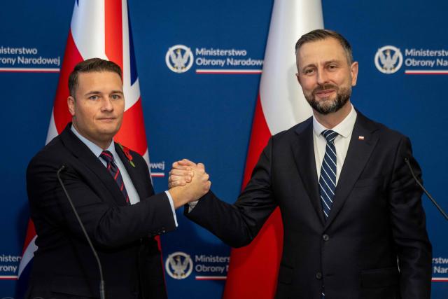 Poland's Deputy Prime Minister and Defence Minister Wladyslaw Kosiniak-Kamysz (R) and Britain's Defence Secretary Wes Streeting (L) shake hands after signing a defence agreement designed to deter Russian threats during a meeting at the Defence Ministry in Warsaw on October 27, 2026. (Photo by Wojtek RADWANSKI / AFP)