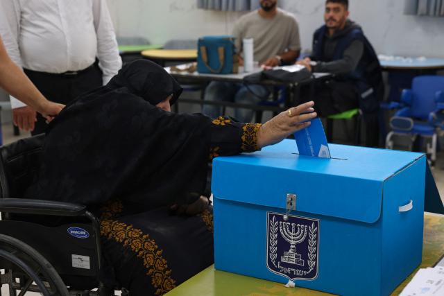 An elderly woman casts her ballot at a polling station in the southern bedouin city of Rahat on October 27, 2026 during Israel's legislative election. A deeply divided Israel headed to the polls for the first time since Hamas's October 7, 2023 attack, with voters delivering their verdict on veteran prime minister and the country's rightward drift. (Photo by HAZEM BADER / AFP)