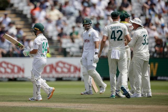 Australia's players celebrate the dismissal of South Africa's Marques Ackerman (L) on day one of the third Test match between South Africa and Australia at Newlands stadium in Cape Town on October 27, 2026. (Photo by Marco Longari / AFP)