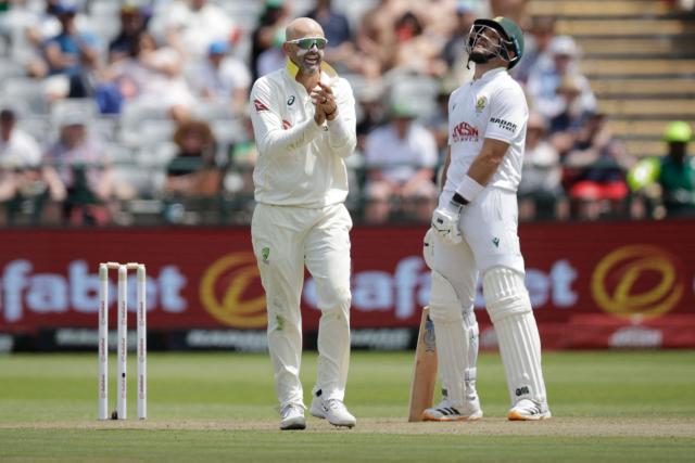South Africa's Aiden Markram (R) reacts as Australia's Nathan Lyon (L) celebrates after dismissing South Africa's Marques Ackerman on day one of the third Test match between South Africa and Australia at Newlands stadium in Cape Town on October 27, 2026. (Photo by Marco Longari / AFP)