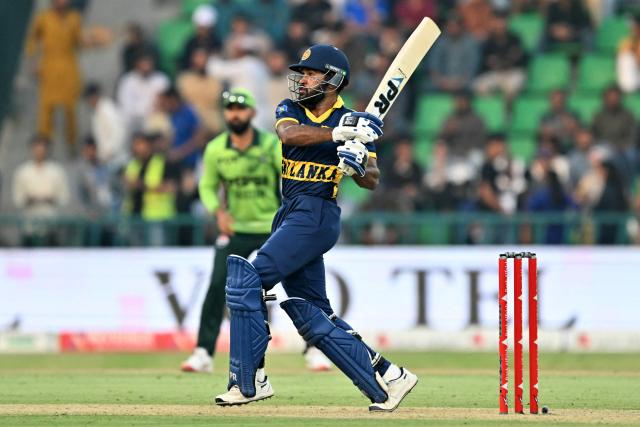 Sri Lanka's Pavan Rathnayake (R) plays a shot during the one-day international (ODI) tri-series cricket match between Pakistan and Sri Lanka at the Gaddafi Stadium in Lahore on October 27, 2026. (Photo by ARIF ALI / AFP)