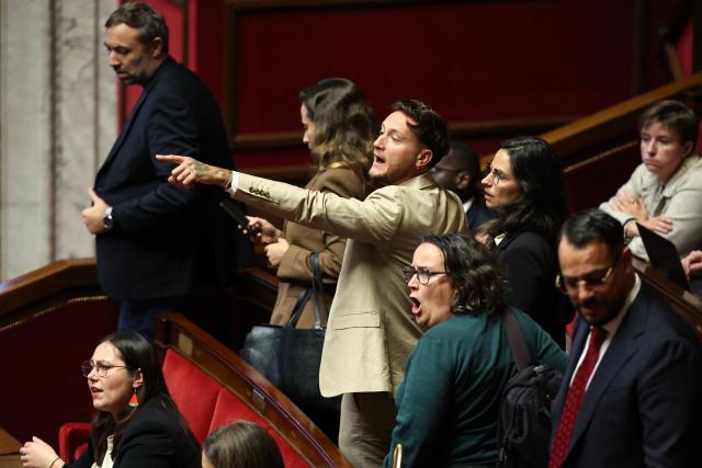 (From L) French leftist party La France Insoumise (LFI) group MPs Marie Mesmeur, Thomas Portes, Clemence Guette, Raphael Arnault, Elise Leboucher, Marianne Maximi and Sebastien Delogu reacts as they walk out of the chamber during a speech by a MP from the French far-right party Rassemblement National (RN) group, as part of a session of questions to the government at The National Assembly, France's lower house of parliament in Paris on October 27, 2026. (Photo by SIMON WOHLFAHRT / AFP)