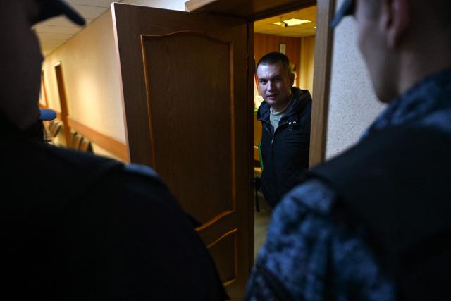 Russian activist Ilya Remeslo, who was arrested in July and charged with "spreading fake information on the Russian army", appears in court for the start of his trial at the Primorsky district court in Saint Petersburg on October 27, 2026. (Photo by Olga MALTSEVA / AFP)