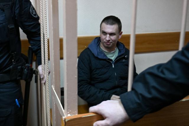 Russian activist Ilya Remeslo, who was arrested in July and charged with "spreading fake information on the Russian army", appears in court for the start of his trial at the Primorsky district court in Saint Petersburg on October 27, 2026. (Photo by Olga MALTSEVA / AFP)