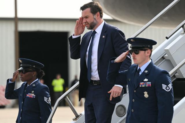 US Vice President JD Vance salutes as he steps off Air Force Two at Bishop International Airport in Flint, Michigan on October 27, 2026. Vance is travelling Michigan to attend a rally ahead of the midterm elections. (Photo by SAUL LOEB / POOL / AFP)