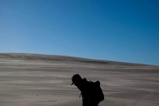 A man visits the Lacka Dune in the Slovincian National Park near the town of Leba, Pomeranian Voivodeship on October 27, 2026. (Photo by Sergei GAPON / AFP)