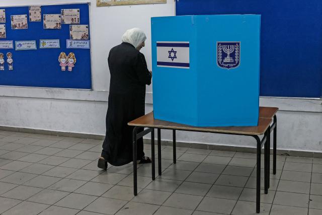 A woman prepares to cast her ballot at a polling station in the Arab-Israeli town of Umm al-Fahm on October 27, 2026, on the day of Israel's legislative election. A deeply divided Israel headed to the polls for the first time since Hamas's October 7, 2023 attack, with voters delivering their verdict on veteran prime minister and the country's rightward drift. (Photo by AHMAD GHARABLI / AFP)