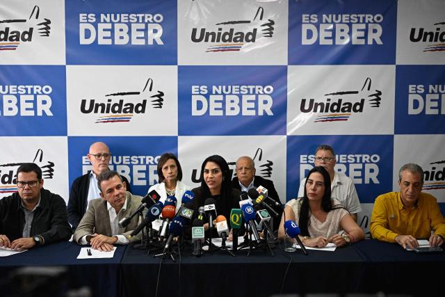 Democratic Unity Movement (MUD) spokesperson Delsa Solorzano (C) speaks with journalists during a press conference in Caracas on October 27, 2026. (Photo by Federico PARRA / AFP)