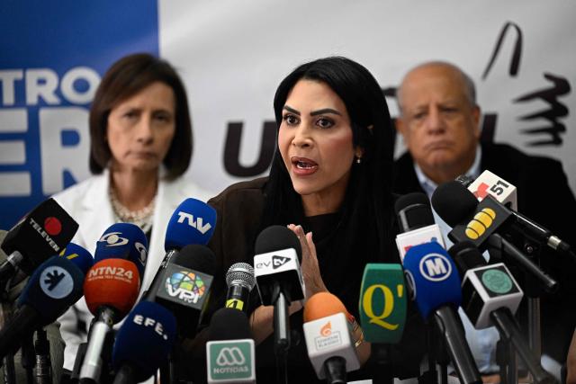 Democratic Unity Movement (MUD) spokesperson Delsa Solorzano (C) speaks to journalists during a press conference in Caracas on October 27, 2026. (Photo by Federico PARRA / AFP)