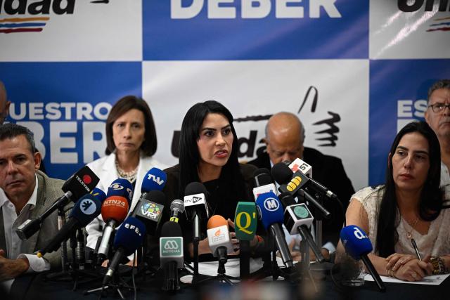 Democratic Unity Movement (MUD) spokesperson Delsa Solorzano (C) speaks with journalists during a press conference in Caracas on October 27, 2026. (Photo by Federico PARRA / AFP)