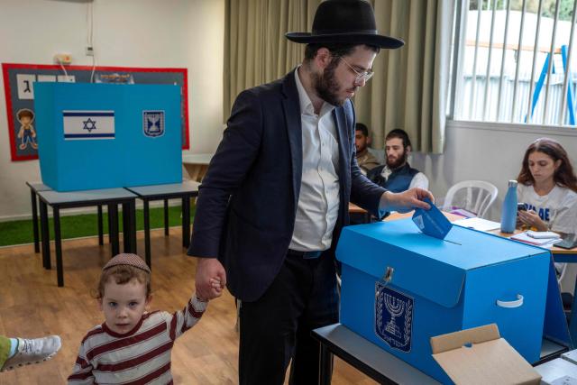 An ultra-Orthodox Jewish man casts his ballot at a polling station in Bnei Brak on October 27, 2026, during Israel's legislative election. A deeply divided Israel headed to the polls for the first time since Hamas's October 7, 2023 attack, with voters delivering their verdict on veteran prime minister and the country's rightward drift. (Photo by Maya Levin / AFP)