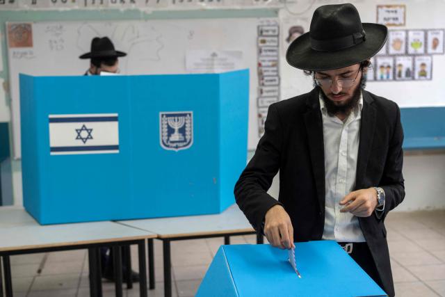 An ultra-Orthodox Jewish man casts his ballot at a polling station in Bnei Brak on October 27, 2026, during Israel's legislative election. A deeply divided Israel headed to the polls for the first time since Hamas's October 7, 2023 attack, with voters delivering their verdict on veteran prime minister and the country's rightward drift. (Photo by Maya Levin / AFP)
