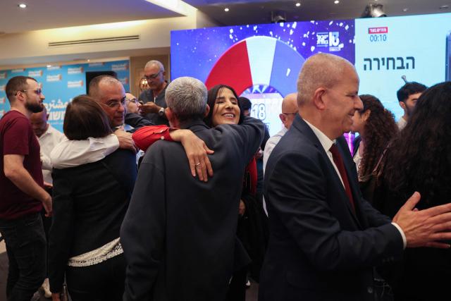 Supporters of Israel's Arab-led Joint List political alliance celebrate at the alliance's campaign headquarters in the northern Israeli city of Nazareth  on October 27, 2026, as the first exit polls are announced on television during Israel's legislative election. Israeli voters on October 27 gave a narrow edge to opposition parties over Prime Minister Benjamin Netanyahu, initial projections showed, after decades-high turnout in the country's first election since the trauma of the October 7, 2023 attacks. (Photo by AHMAD GHARABLI / AFP)