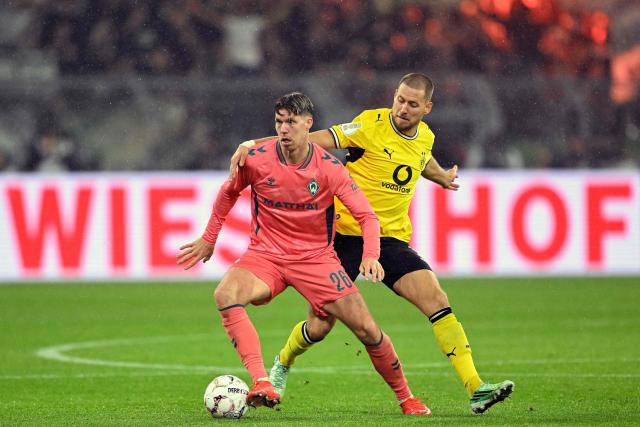Bremen's Swiss forward #26 Cedric Itten (R) and Dortmund's German defender #03 Waldemar Anton vie for the ball during the German Cup (DFB-Pokal) football match between BVB Borussia Dortmund and Werder Bremen in Dortmund, western Germany on October 27, 2026. (Photo by INA FASSBENDER / AFP) / DFB REGULATIONS PROHIBIT ANY USE OF PHOTOGRAPHS AS IMAGE SEQUENCES AND QUASI-VIDEO.