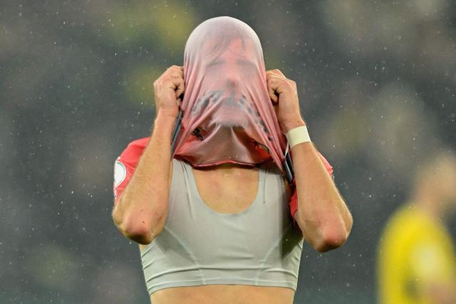 Players including Bremen's German defender #33 Mick Schmetgens react after the German Cup (DFB-Pokal) football match between BVB Borussia Dortmund and Werder Bremen in Dortmund, western Germany on October 27, 2026. (Photo by INA FASSBENDER / AFP) / DFL REGULATIONS PROHIBIT ANY USE OF PHOTOGRAPHS AS IMAGE SEQUENCES AND/OR QUASI-VIDEO   ALTERNATIVE CROP