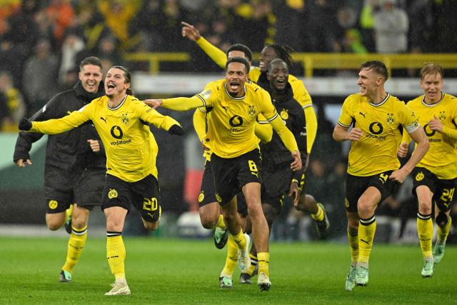 Dortmund's Austrian midfielder #20 Marcel Sabitzer celebrates scoring the 3-2 goal with his teammates during the German Cup (DFB-Pokal) football match between BVB Borussia Dortmund and Werder Bremen in Dortmund, western Germany on October 27, 2026. (Photo by INA FASSBENDER / AFP) / DFB REGULATIONS PROHIBIT ANY USE OF PHOTOGRAPHS AS IMAGE SEQUENCES AND QUASI-VIDEO.