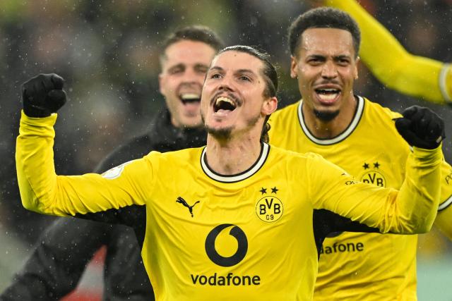 Dortmund's Austrian midfielder #20 Marcel Sabitzer celebrates scoring the 3-2 goal with his teammates during the German Cup (DFB-Pokal) football match between BVB Borussia Dortmund and Werder Bremen in Dortmund, western Germany on October 27, 2026. (Photo by INA FASSBENDER / AFP) / DFB REGULATIONS PROHIBIT ANY USE OF PHOTOGRAPHS AS IMAGE SEQUENCES AND QUASI-VIDEO.