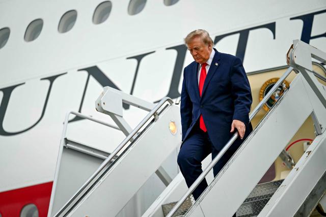 US President Donald Trump disembarks from Air Force One at Lubbock Preston Smith International Airport in Lubbock, Texas on October 27, 2026. President Trump is travelling to Texas to attend midterm campaign rallies. (Photo by Kent NISHIMURA / AFP)