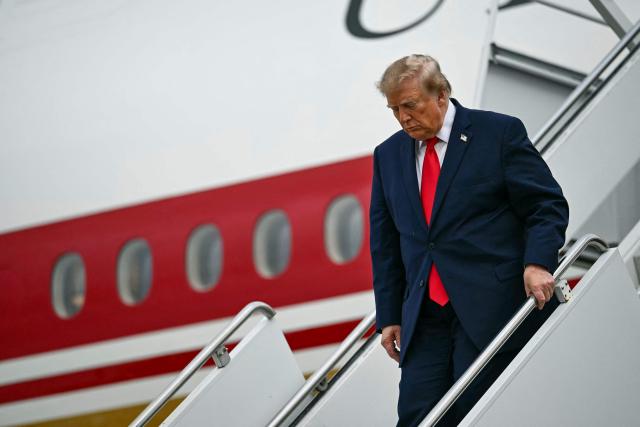US President Donald Trump disembarks from Air Force One at Lubbock Preston Smith International Airport in Lubbock, Texas on October 27, 2026. President Trump is travelling to Texas to attend midterm campaign rallies. (Photo by Kent NISHIMURA / AFP)