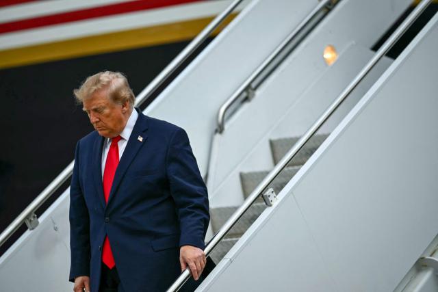 US President Donald Trump disembarks from Air Force One at Lubbock Preston Smith International Airport in Lubbock, Texas on October 27, 2026. President Trump is travelling to Texas to attend midterm campaign rallies. (Photo by Kent NISHIMURA / AFP)