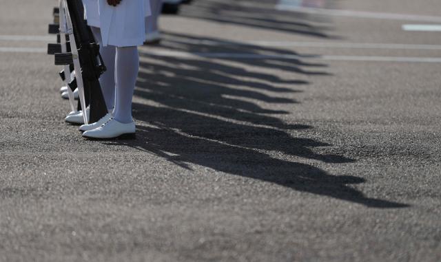 Shadows of the honour guard, made up of members of the Royal Bahamas Police Force and the Royal Bahamas Defence Force, are seen on the tarmac as they await the arrival of Britain's King Charles III at Lynden Pindling International Airport in Nassau, The Bahamas on October 27, 2026. King Charles III is arriving to begin a weeks long tour of The Bahamas, Guyana and Antigua & Barbuda. (Photo by Ben Stansall / POOL / AFP)