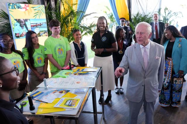 Britain's King Charles III looks at displays from the next generation of Bahamians during a youth rally at Clifford Park in Nassau, The Bahamas, on October 27, 2026. King Charles III is starting a Caribbean tour visiting The Bahamas, Guyana and finally Antigua & Barbuda, where he will attend the 28th Commonwealth Heads of Government Meeting (CHOGM). (Photo by Ben Stansall / POOL / AFP)
