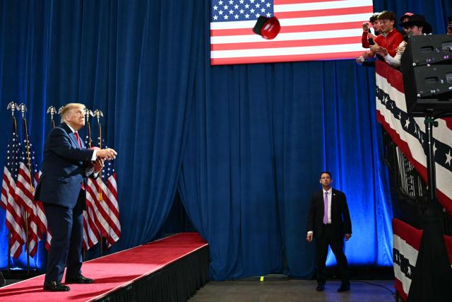 US President Donald Trump throws MAGA hats to supporters during a midterm campaign rally at Lubbock Memorial Civic Center in Lubbock, Texas on October 27, 2026. (Photo by Kent NISHIMURA / AFP)