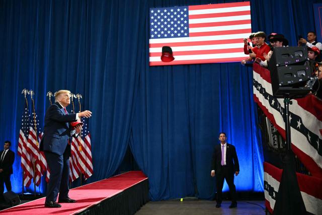 US President Donald Trump throws MAGA hats to supporters during a midterm campaign rally at Lubbock Memorial Civic Center in Lubbock, Texas on October 27, 2026. (Photo by Kent NISHIMURA / AFP)