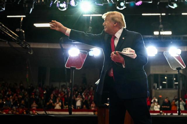 US President Donald Trump throws MAGA hats to supporters during a midterm campaign rally at Lubbock Memorial Civic Center in Lubbock, Texas on October 27, 2026. (Photo by Kent NISHIMURA / AFP)