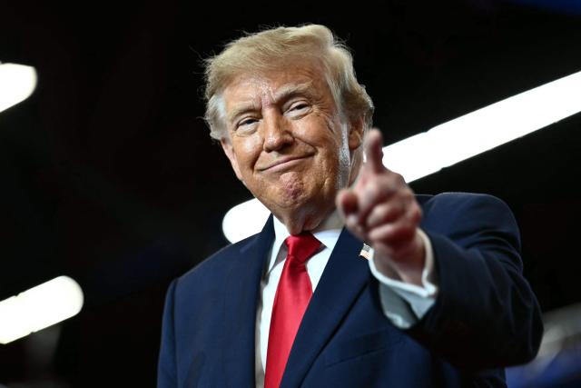 US President Donald Trump greets supporters as he arrives for a midterm campaign rally at Lubbock Memorial Civic Center in Lubbock, Texas on October 27, 2026. (Photo by Kent NISHIMURA / AFP)