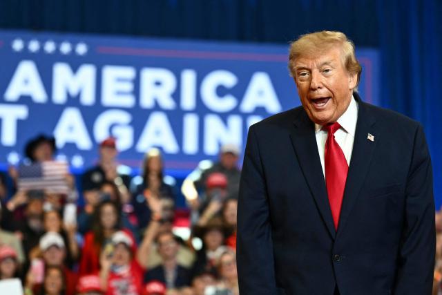 US President Donald Trump greets supporters as he arrives for a midterm campaign rally at Lubbock Memorial Civic Center in Lubbock, Texas on October 27, 2026. (Photo by Kent NISHIMURA / AFP)