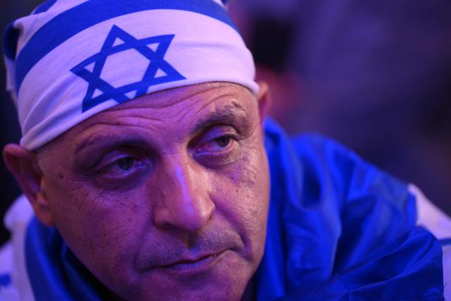A supporter waits for the arrival of Israel's Prime Minister Benjamin Netanyahu at the election night rally after the first exit polls were announced, in Jerusalem on early October 28, 2026, during Israel's legislative elections. Israeli voters on October 27 gave a narrow edge to opposition parties over Netanyahu, initial projections showed, after decades-high turnout in the country's first election since the trauma of the October 7, 2023 attacks. (Photo by Jewel SAMAD / AFP)