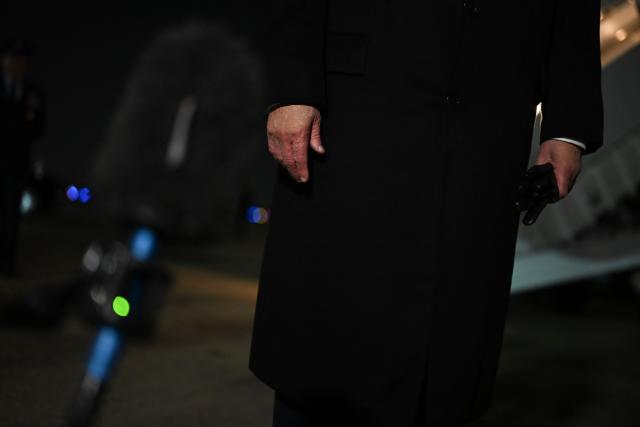 Details of US President Donald Trump's hands are seen as he speaks to members of the media after disembarking from Air Force One at Joint Base Andrews, Maryland during the early hours of October 28, 2026. President Trump is returning from Texas where he attended midterm campaign rallies. (Photo by Kent NISHIMURA / AFP)