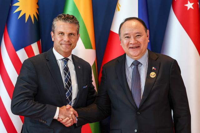 US Defence Secretary Pete Hegseth (L) is welcomed by Philippines' Defence Secretary Gilberto Teodoro (R) during the Association of Southeast Asian Nations (ASEAN) Defence Ministers' Informal Meeting with the United States in Cebu, central Philippines, on October 28, 2026. (Photo by ELOISA LOPEZ / POOL / AFP)