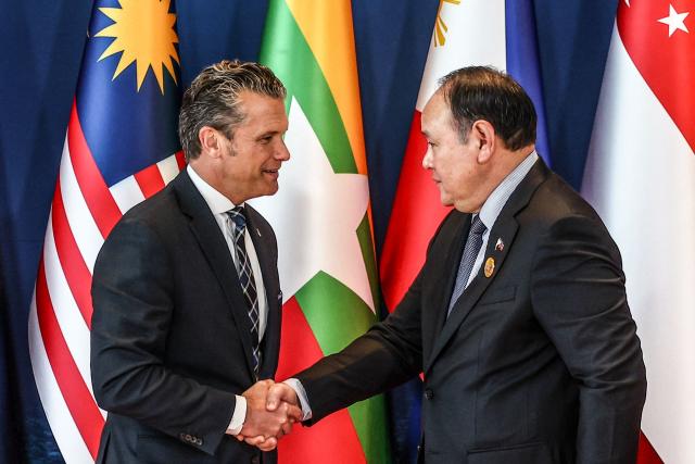 US Defence Secretary Pete Hegseth (L) is welcomed by Philippines' Defence Secretary Gilberto Teodoro (R) during the Association of Southeast Asian Nations (ASEAN) Defence Ministers' Informal Meeting with the United States in Cebu, central Philippines, on October 28, 2026. (Photo by ELOISA LOPEZ / POOL / AFP)