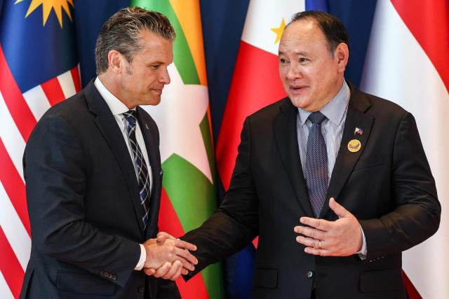 US Defence Secretary Pete Hegseth (L) is welcomed by Philippines' Defence Secretary Gilberto Teodoro (R) during the Association of Southeast Asian Nations (ASEAN) Defence Ministers' Informal Meeting with the United States in Cebu, central Philippines, on October 28, 2026. (Photo by ELOISA LOPEZ / POOL / AFP)