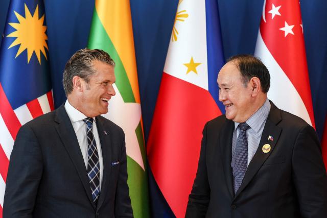 US Defence Secretary Pete Hegseth (L) is welcomed by Philippines' Defence Secretary Gilberto Teodoro (R) during the Association of Southeast Asian Nations (ASEAN) Defence Ministers' Informal Meeting with the United States in Cebu, central Philippines, on October 28, 2026. (Photo by ELOISA LOPEZ / POOL / AFP)