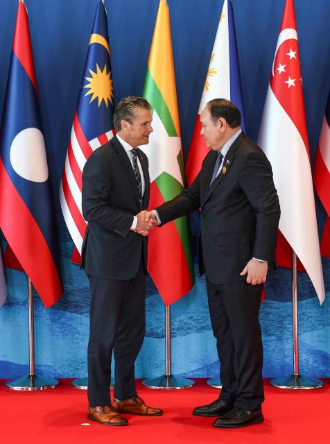 US Defence Secretary Pete Hegseth (L) is welcomed by Philippines' Defence Secretary Gilberto Teodoro (R) during the Association of Southeast Asian Nations (ASEAN) Defence Ministers' Informal Meeting with the United States in Cebu, central Philippines, on October 28, 2026. (Photo by Eloisa Lopez / POOL / AFP)