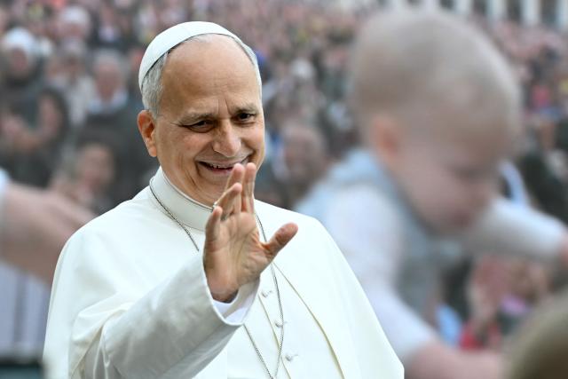 Pope Leo XIV waves to pilgrims gathered in St. Peter's Square as he arrives to lead the weekly general audience at The Vatican on October 28, 2026. (Photo by Filippo MONTEFORTE / AFP)