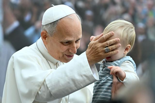 Pope Leo XIV blesses a young faithful along with pilgrims gathered in St. Peter's Square as he arrives to lead the weekly general audience at The Vatican on October 28, 2026. (Photo by Filippo MONTEFORTE / AFP)