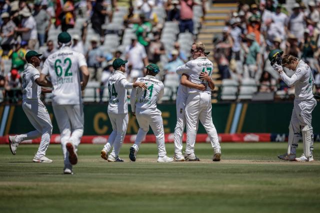 South Africa's Simon Harmer (2nd R) celebrates with his teammates after dismissing Australia's Travis Head on day two of the third Test match between South Africa and Australia at Newlands stadium in Cape Town on October 28, 2026. (Photo by Marco Longari / AFP)