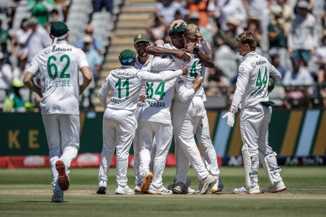 South Africa's Simon Harmer (2nd R) celebrates with his teammates after dismissing Australia's Travis Head on day two of the third Test match between South Africa and Australia at Newlands stadium in Cape Town on October 28, 2026. (Photo by Marco Longari / AFP)