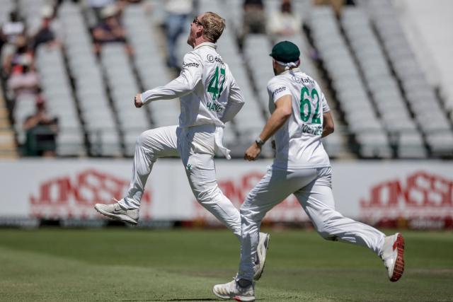 South Africa's Simon Harmer (L) celebrates after dismissing Australia's Marnus Labuschagne on day two of the third Test match between South Africa and Australia at Newlands stadium in Cape Town on October 28, 2026. (Photo by Marco Longari / AFP)